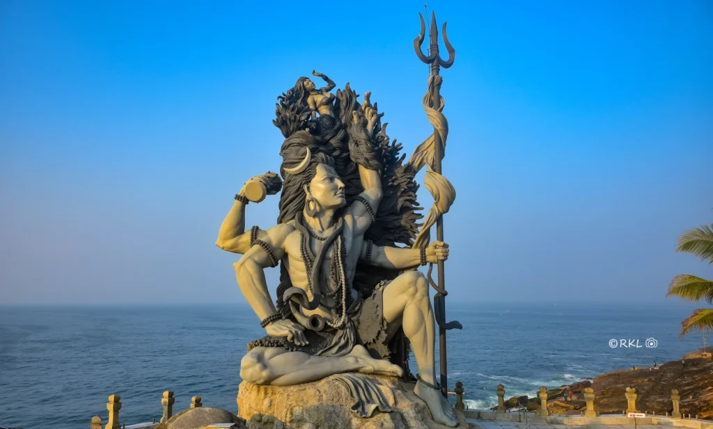 Aazhimala Shiva Temple, located near Matha Tourist Home in Trivandrum, featuring a stunning cliffside location with a 58-feet tall statue of Lord Shiva overlooking the Arabian Sea